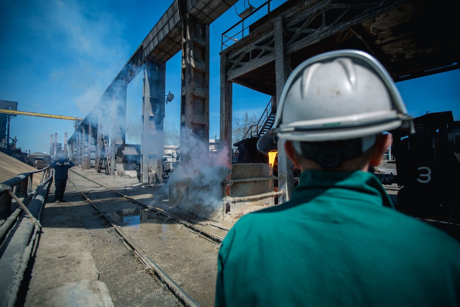 Engineer overlooking an industrial steel site